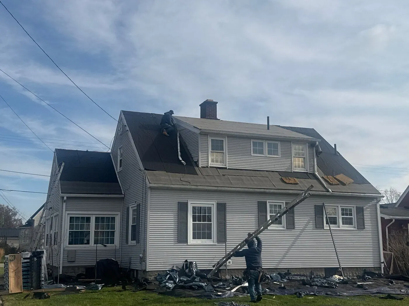 Crew tearing off an old roof