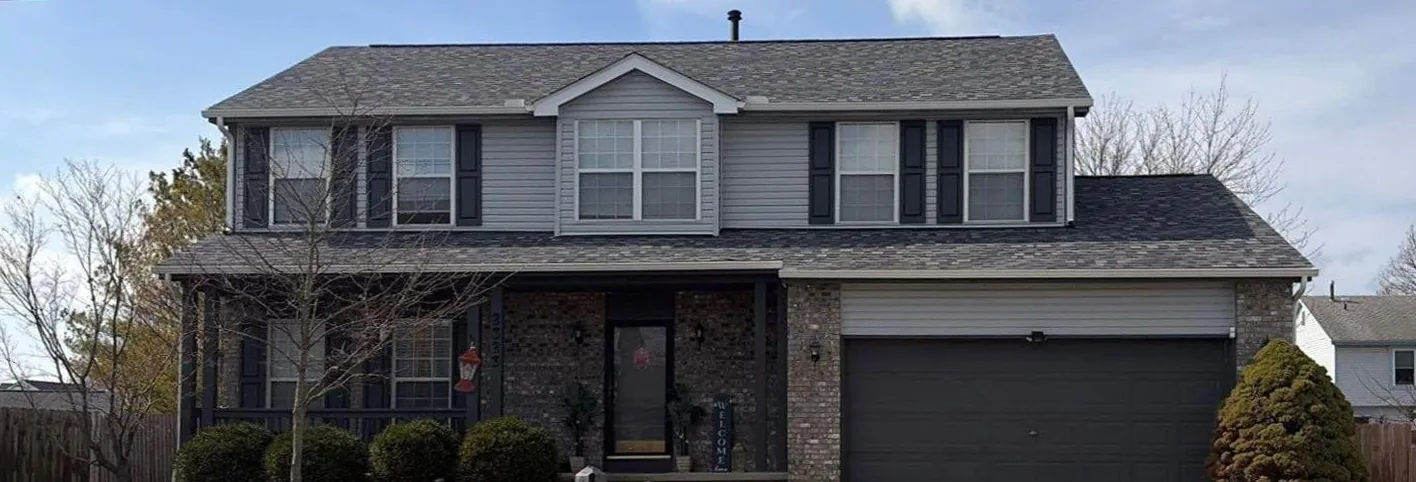 Two-story brick home in Central Ohio with a new roof installed by Lifetime Roofing