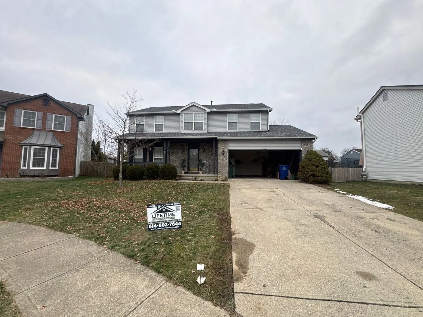 Central Ohio home after a new roof by Lifetime Roofing, with company yard sign